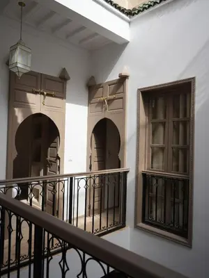 a balcony with two doors and a railing at Riad privatif Les Tamaris in Marrakech