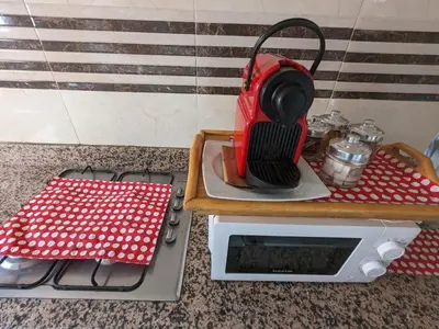 a red blender sitting on top of a microwave at Rooftop apartment with large terrace in Guéliz in Marrakech