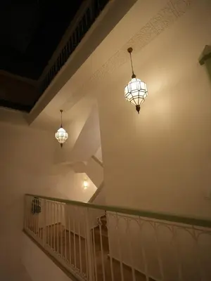 two lights hanging from a staircase in a house at Riad privatif Les Ibéris in Marrakech