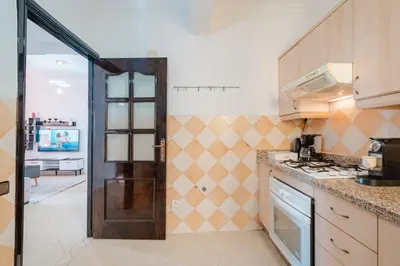 a kitchen with a door leading into a room at Appartement 2 chambres avec terrasse ensoleillée in Marrakech