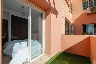 a room with a bed outside of a window at Appartement 2 chambres avec terrasse ensoleillée in Marrakech