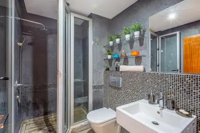 a bathroom with a toilet and a sink and a shower at superbe appartement au coeur de guiliz - victor Hugo in Marrakech