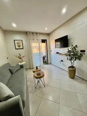 a living room with a couch and a table at New! Apartment F2 Gueliz Station Balcony renovated in Marrakech