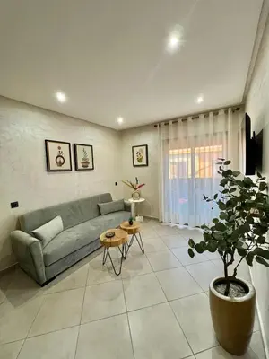 a living room with a couch and a potted plant at New! Apartment F2 Gueliz Station Balcony renovated in Marrakech