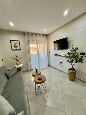 a living room with a couch and a tv at New! Apartment F2 Gueliz Station Balcony renovated in Marrakech