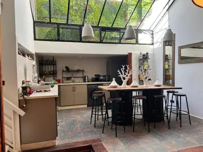 a kitchen with a bar with stools in it at Loft Harmonia in Marrakech