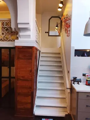 a staircase leading up to a kitchen with white stairs at Loft Harmonia in Marrakech
