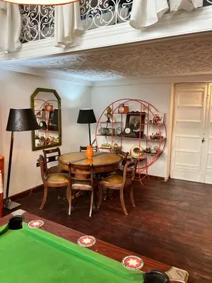 a dining room with a table and a pool table at Loft Harmonia in Marrakech