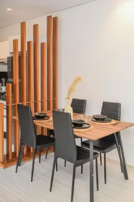 a dining room table with chairs and a vase on it at Éminence Living in Marrakech