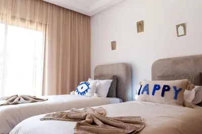 a bedroom with two beds with happy towels on them at Charming two-bedroom with terrace in Marrakesh in Marrakech