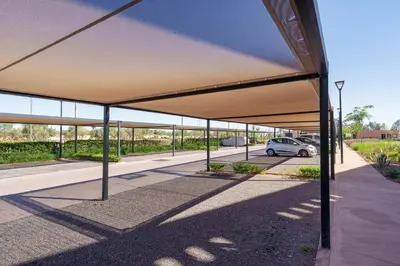 an empty parking lot with a car parked under a canopy at Charming two-bedroom with terrace in Marrakesh in Marrakech