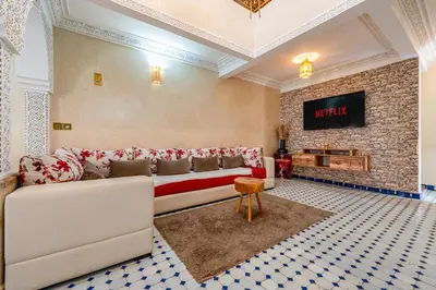 a living room with a couch and a fireplace at Elegant 3-Bedroom Duplex with Pool in Marrakech