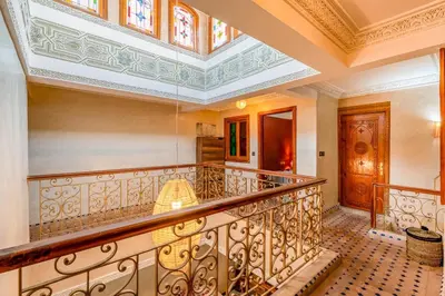 an ornate staircase in a house with a ceiling at Elegant 3-Bedroom Duplex with Pool in Marrakech