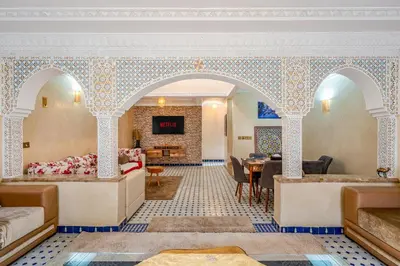a hotel room with a bed and a table at Elegant 3-Bedroom Duplex with Pool in Marrakech