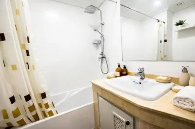 a bathroom with a sink and a bath tub at Marrakech Guéliz Piscine & Terrasses Ensoleillées in Marrakech