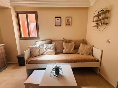 a living room with a couch and a table at Suite Amethyste - Majorelle in Marrakech
