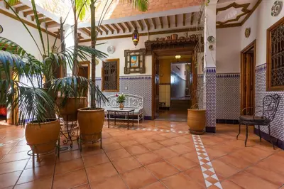 a lobby with potted plants in a building at Hotel Atlas in Marrakech
