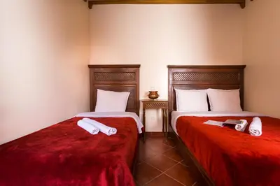 two beds sitting next to each other in a room at Hotel Atlas in Marrakech