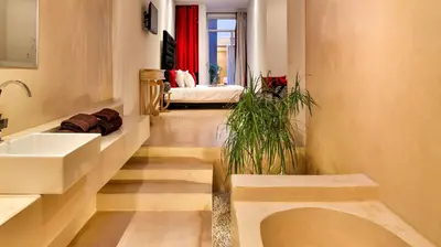 a bathroom with a sink and a plant on the floor at Ryad Marrakech in Marrakech