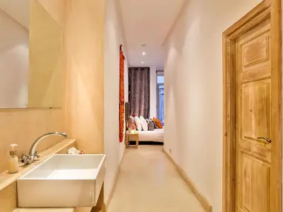a bathroom with a sink and a bed in a room at Ryad Marrakech in Marrakech
