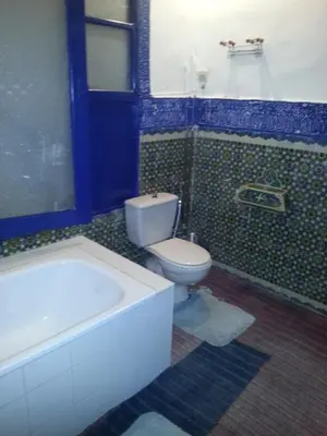 a bathroom with a toilet and a bath tub at Riad Dar Kader chambre bleue in Marrakech