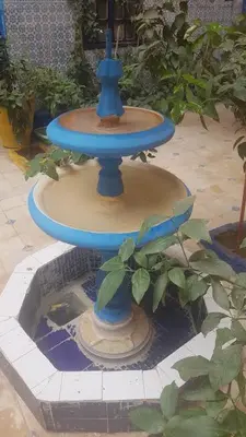 a blue bird bath sitting on top of a fountain at Riad Dar Kader chambre bleue in Marrakech