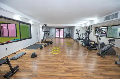 a gym with several treadmills and exercise machines at Oliva Hotel Condominium Marrakech in Marrakech