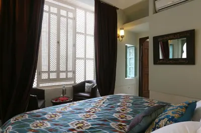 a bedroom with a bed and a large window at Riad Dar Ayur in Marrakech