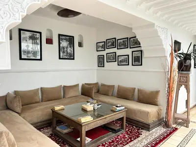 a living room with a couch and a table at Riad Argan in Marrakech