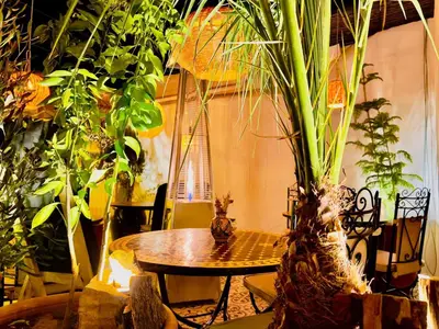 a table in a room with lots of plants at Riad Argan in Marrakech