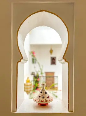 a vase sitting on a shelf in an archway at Riad des Lys in Marrakech