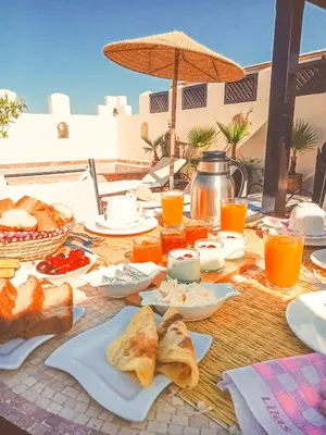 a picnic table with food and drinks on it at Riad des Lys in Marrakech