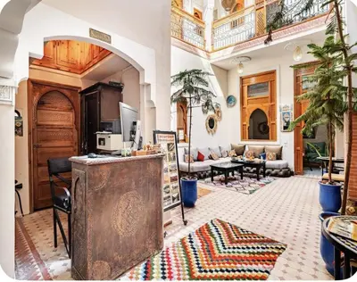 a large living room with a counter and a living room at Riad Jenan Adam in Marrakech