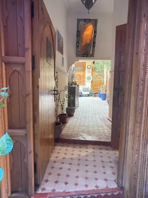 a hallway with a door and a tile floor at Riad Jenan Adam in Marrakech