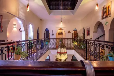 a staircase in a building with a wrought iron railing at Riad El Walida in Marrakech