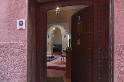 an open door into a room with a pink wall at Riad El Walida in Marrakech