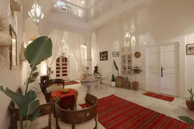 a large living room with a table and chairs at Riad Morocco Sky in Marrakech