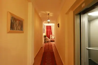 a long hallway with a red rug on the floor at Dar Guéliz in Marrakech
