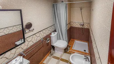 a small bathroom with a toilet and a sink at Hôtel Les Ambassadeurs in Marrakech