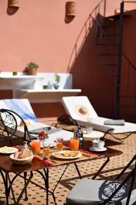 a table with plates of food and drinks on it at Riad Lamzia in Marrakech