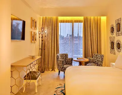a hotel room with a bed and a table and chairs at 2Ciels Boutique Hôtel in Marrakech