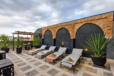a group of chairs sitting on a patio at Riad Dar El Masa in Marrakech