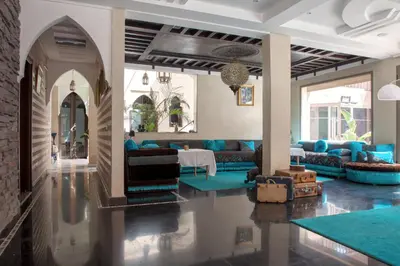 a living room with blue couches and a table at Dar Al Walidine in Marrakech