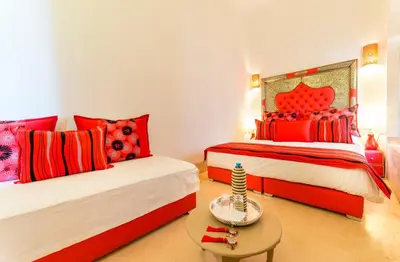 two beds in a room with red and white at Riad See Moon And Spa in Marrakech