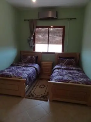 a bedroom with two beds and a window at Apartment Twins 12 in Marrakech
