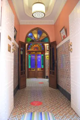 a hallway with doors and a tiled floor at Riad Hôtel Essaouira in Marrakech