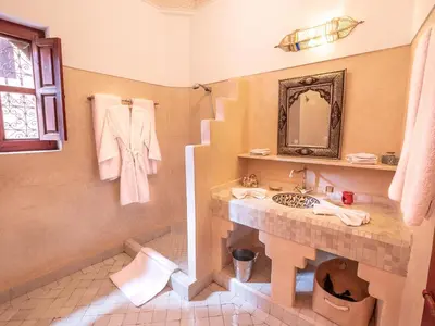 a bathroom with a sink and a mirror at Riad Passali in Marrakech