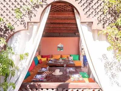 an open stairway with a table and chairs in a building at Riad Passali in Marrakech