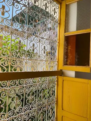 a gate on the side of a building with a door at The Madrassa Hostel in Marrakech