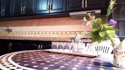 a table with glasses on a counter in a kitchen at Villa Annakhil in Marrakech